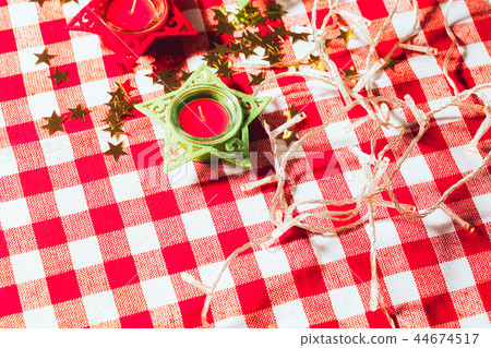 candle on red checkered tablecloths and garland candle on red checkered tablecloths and garland 44674517