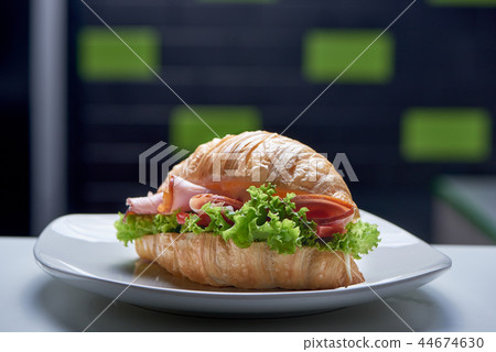 Closeup of croissant with greens, ham and vegetables in pub Closeup of croissant with greens, ham and vegetables in pub 44674630