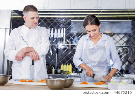 Pretty woman learning cooking science together with a chef 44675210