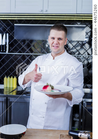 Motivated cook introducing his dish to the chef 44675260