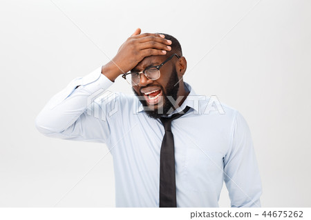 Portrait of desperate annoyed black male screaming in rage and anger tearing his hair out while 44675262