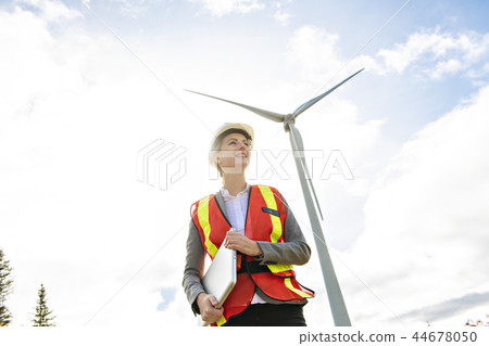 A Technician woman Engineer in Wind Turbine Power Generator Station 44678050