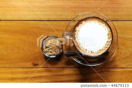 Hot coffee cup with cane sugar on wooden table 44679113