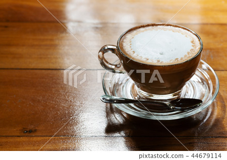 Hot coffee cup on the wooden table, underexposure Hot coffee cup on the wooden table, underexposure 44679114