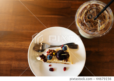 Piece of carrot fruit cake and ice coffee Piece of carrot fruit cake and ice coffee 44679156