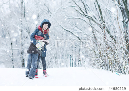 two sisters girls winter for a walk / young girlfriends playing in the snow in the frost. The concept of childhood, friendship, family. Sports warm clothes, health immunity. Christmas morning. two sisters girls winter for a walk / young girlfriends playing in the snow in the frost. The concept of childhood, friendship, family. Sports warm clothes, health immunity. Christmas morning. 44680219