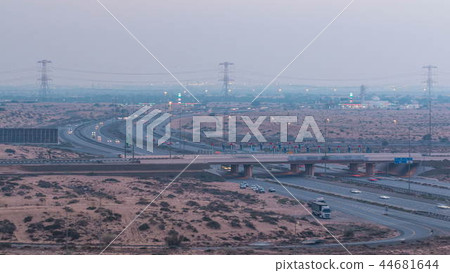 Highway roads with traffic day to night timelapse in a big city from Ajman to Dubai before sunset. Transportation concept. Highway roads with traffic day to night timelapse in a big city from Ajman to Dubai before sunset. Transportation concept. 44681644