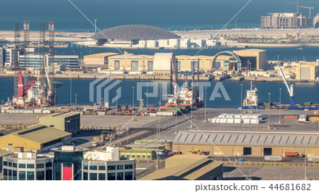 Big cargo ship at industrial port timelapse aerial fiew from above at evening in Abu Dhabi 44681682