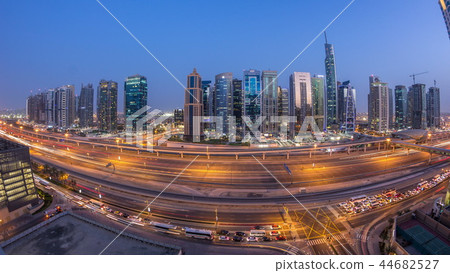 Aerial view of Jumeirah lakes towers skyscrapers day to night timelapse with traffic on sheikh zayed road. Aerial view of Jumeirah lakes towers skyscrapers day to night timelapse with traffic on sheikh zayed road. 44682527