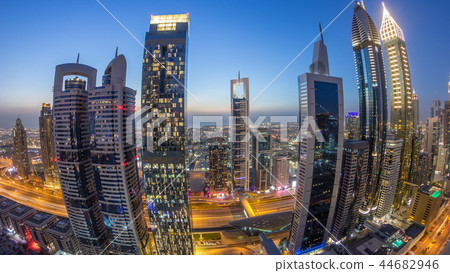 Skyline view of the buildings of Sheikh Zayed Road and DIFC day to night timelapse in Dubai, UAE. 44682946