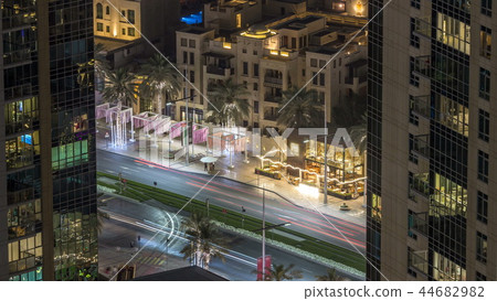 Birds eye view of Dubai skyline timelapse and rush hour traffic in downtown at night 44682982