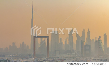 Dubai creek landscape timelapse with boats and ship near waterfront and modern buildings in the background during sunset 44683035