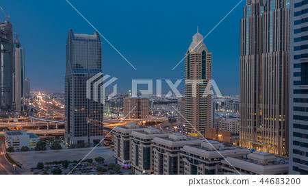 Dubai downtown skyline night to day timelapse and Sheikh Zayed road traffic, UAE 44683200