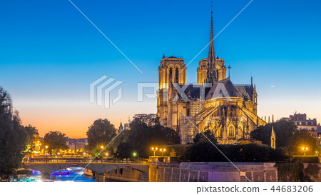 Rear view of Notre Dame De Paris cathedral day to night timelapse after sunset. Rear view of Notre Dame De Paris cathedral day to night timelapse after sunset. 44683206
