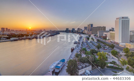Dubai creek landscape at sunset timelapse with boats and ship near waterfront 44683306