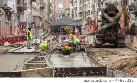 Concrete works for road maintenance construction with many workers and mixer timelapse Concrete works for road maintenance construction with many workers and mixer timelapse 44683322