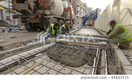 Pouring ready-mixed concrete after placing steel reinforcement to make the road by concrete mixer timelapse hyperlapse. 44683325