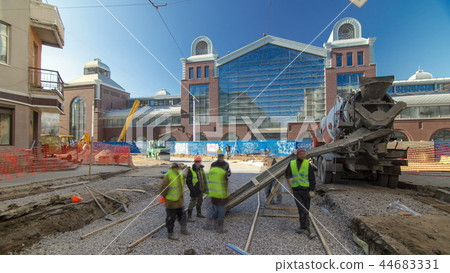 Concrete works for road maintenance construction with many workers and mixer timelapse 44683331