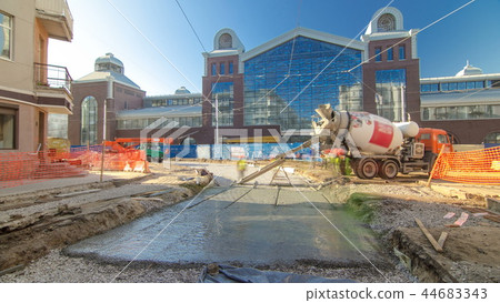Concrete works for road maintenance construction with many workers and mixer timelapse 44683343