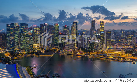 A view of Singapore business district skyscrapers at evening with water reflections day to night timelapse A view of Singapore business district skyscrapers at evening with water reflections day to night timelapse 44683549