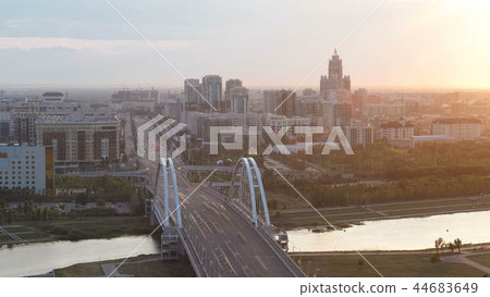 Sunset timelapse above the Bridge with the transport and clouds on the background. Central Asia, Kazakhstan, Astana Sunset timelapse above the Bridge with the transport and clouds on the background. Central Asia, Kazakhstan, Astana 44683649