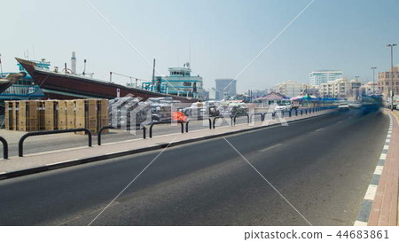 Boats at Port Saeed along Deira's shore of Dubai Creek, UAE. Timelapse view from road 44683861
