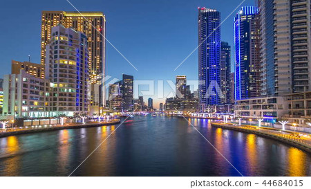 View of Dubai Marina Towers and canal in Dubai day to night timelapse 44684015