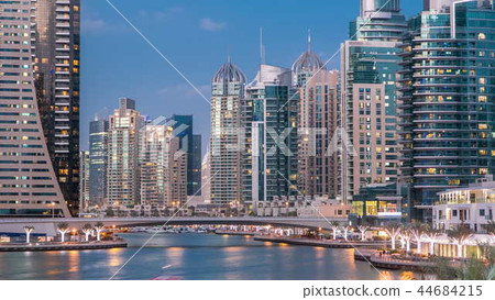 View of Dubai Marina Towers and canal in Dubai day to night timelapse View of Dubai Marina Towers and canal in Dubai day to night timelapse 44684215