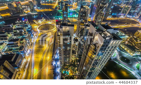 Scenic aerial view of a big modern city at night timelapse. Business bay, Dubai, United Arab Emirates. Scenic aerial view of a big modern city at night timelapse. Business bay, Dubai, United Arab Emirates. 44684337
