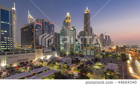 Downtown Dubai towers day to night timelapse. Aerial view of Sheikh Zayed road with skyscrapers after sunset. Downtown Dubai towers day to night timelapse. Aerial view of Sheikh Zayed road with skyscrapers after sunset. 44684340