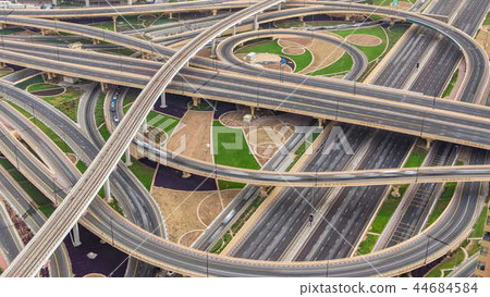 Aerial view of highway junction with traffic timelapse in Dubai, UAE, at sunset. Famous Sheikh Zayed road in Dubai downtown. 44684584