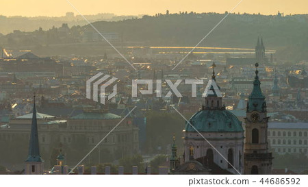 Spires of the old town and St Nicolas church at sunrise timelapse. czech republic, prague Spires of the old town and St Nicolas church at sunrise timelapse. czech republic, prague 44686592