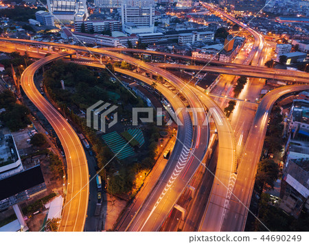Cars driving on bridge roads shaped curve highways with skyscrap 44690249