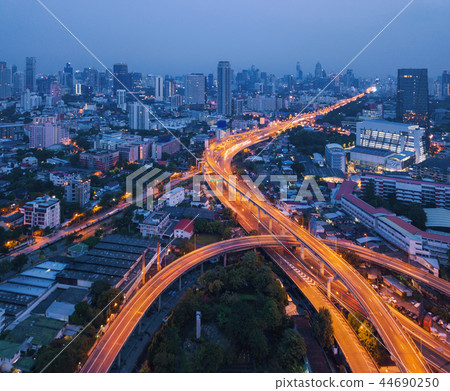 Cars driving on bridge roads shaped curve highways with skyscrap Cars driving on bridge roads shaped curve highways with skyscrap 44690250