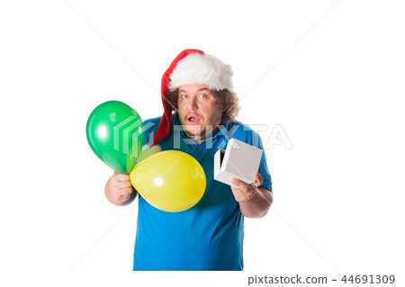 Funny fat man in Santa hat with balloons and gifts. Christmas and presents Funny fat man in Santa hat with balloons and gifts. Christmas and presents 44691309