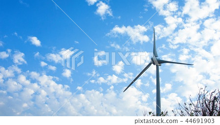 An upright towering wind turbine windmill sightseeing spot blue good angle green light green energy 44691903