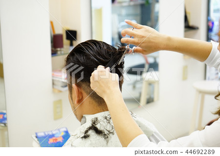Beauty salon scene Men's cut image perming stock photos 44692289