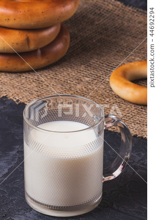 Milk in a cup with bagels on the table Milk in a cup with bagels on the table 44692294