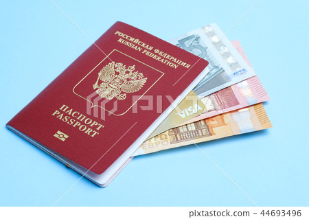 Euro banknotes and VISA card enclosed in a foreign Russian passport isolated on a blue background Euro banknotes and VISA card enclosed in a foreign Russian passport isolated on a blue background 44693496