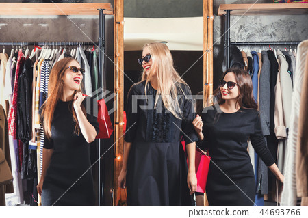 Positive Girls Doing Shopping On Black Friday Sale Positive Girls Doing Shopping On Black Friday Sale 44693766