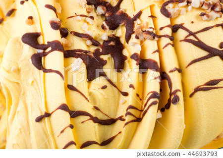 Mass of orange ice-cream with chocolate syrop.  44693793