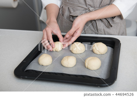 Hand of young woman hand making bread Hand of young woman hand making bread 44694526