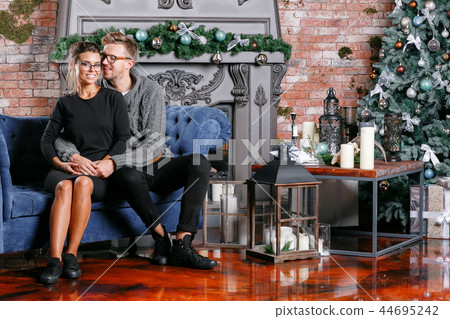 Young beautiful couple In loft room with brick wall. Happy new year. decorated Christmas tree 44695242