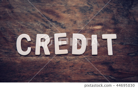 The word "CREDIT" is arranged from a wooden 44695830