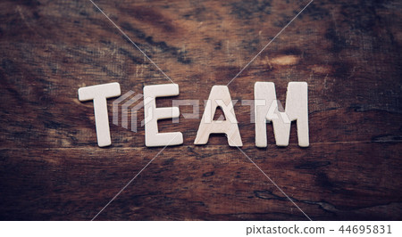The word "TEAM" is arranged from a wooden The word "TEAM" is arranged from a wooden 44695831