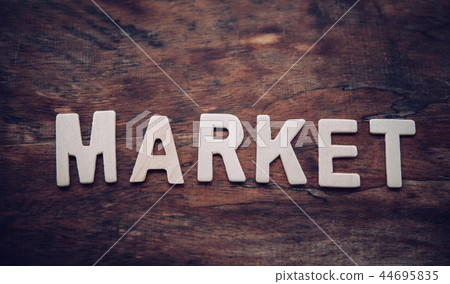 Place the word "MARKET" white on the wooden floor. Place the word "MARKET" white on the wooden floor. 44695835