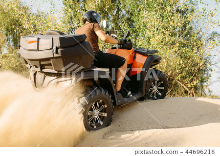 Atv riding in action, sand quarry on background 44696218