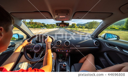 Driver's hands on a steering wheel of a car Driver's hands on a steering wheel of a car 44696808