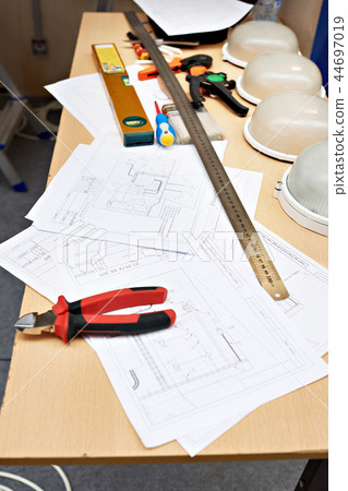Electrician working place with drawings and tools 44697019