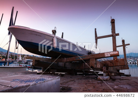 Motor boat is under repair in port of Ajaccio Motor boat is under repair in port of Ajaccio 44698672